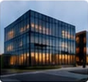 Glass office building outfitted with Circular systems at dusk